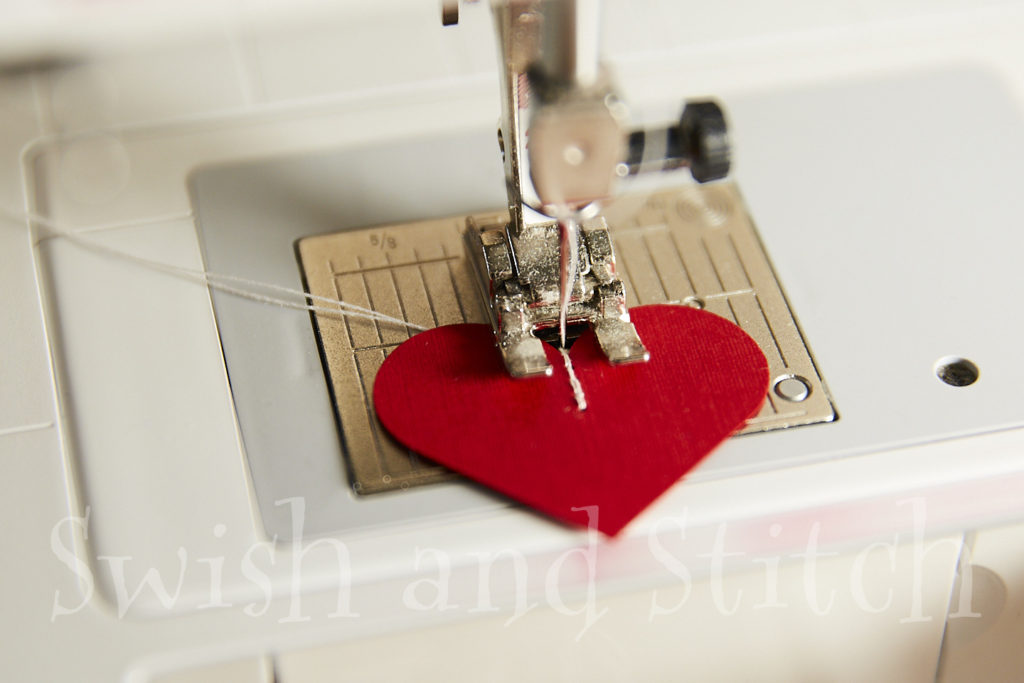 Locking in threads at the beginning of the Valentine heart paper garland