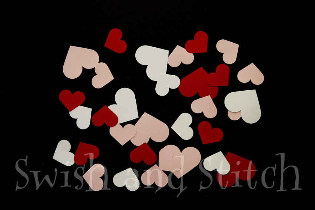 punched paper hearts for Valentine garland