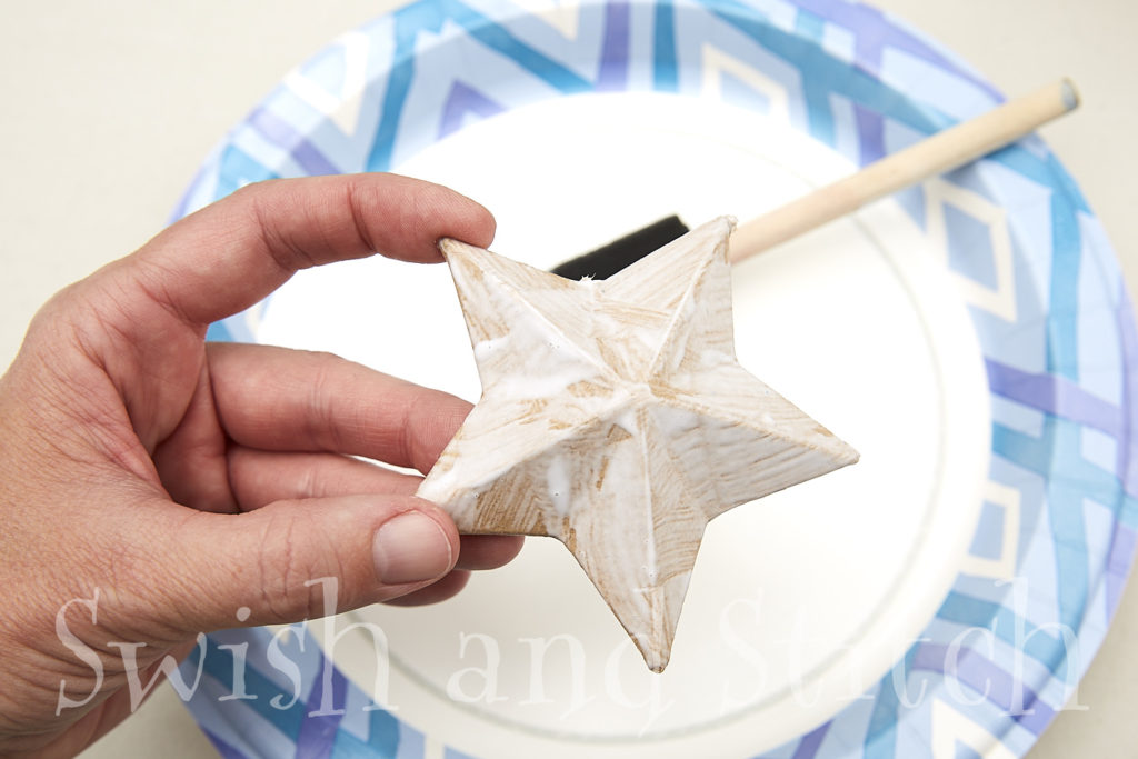 Mod Podge on the front of the papier mache star