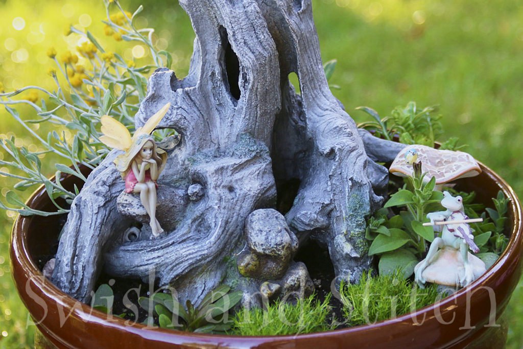 fairy garden with frog playing fiddle