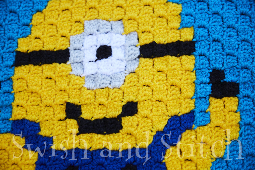 minion crochet on blue closeup