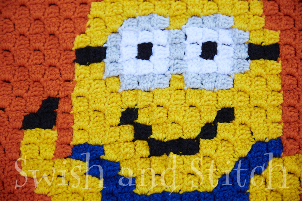 Closeup of crocheted Minions block