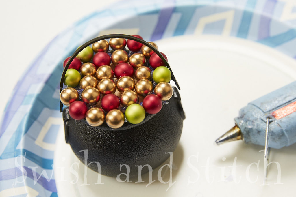 first layer of berry beads on cauldron ornament