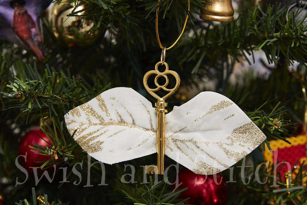 winged key ornament on tree