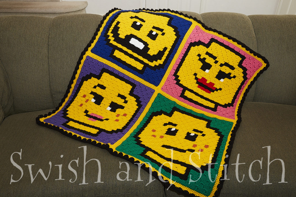 lego brick face family c2c crochet afghan on couch