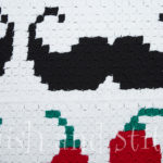 fiesta c2c crochet closeup with mustache and chile peppers
