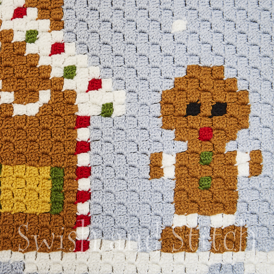 closeup of gingerbread boy and house