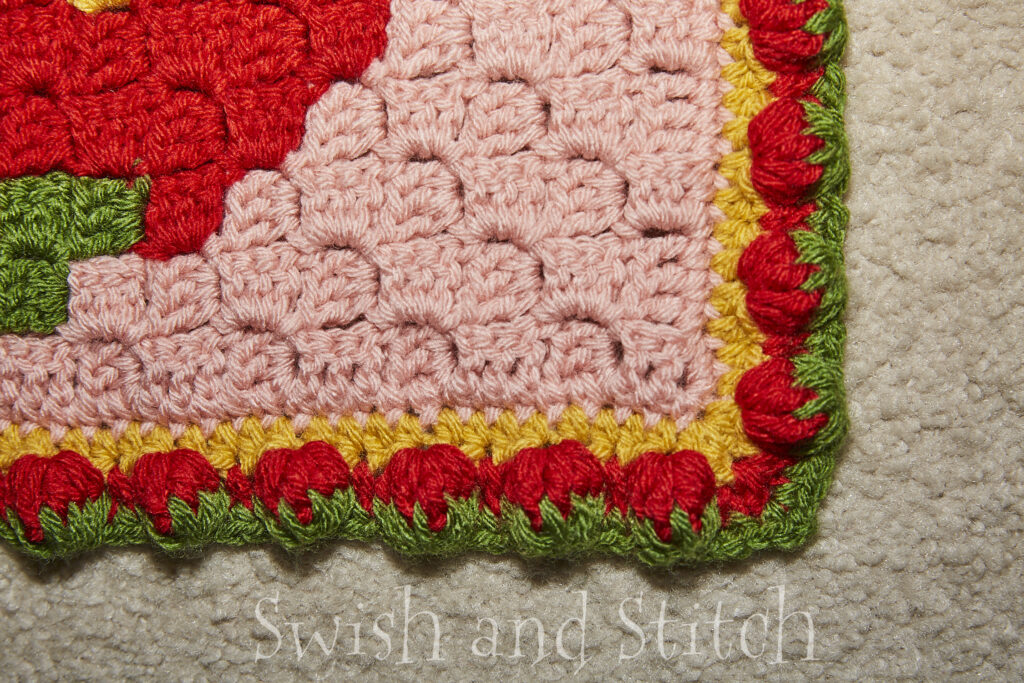 Closeup of strawberry puff stitch edging