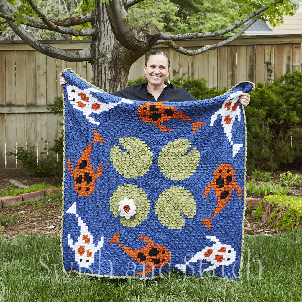 Tranquil Koi Pond C2C Croceht Throw Afghan held by designer