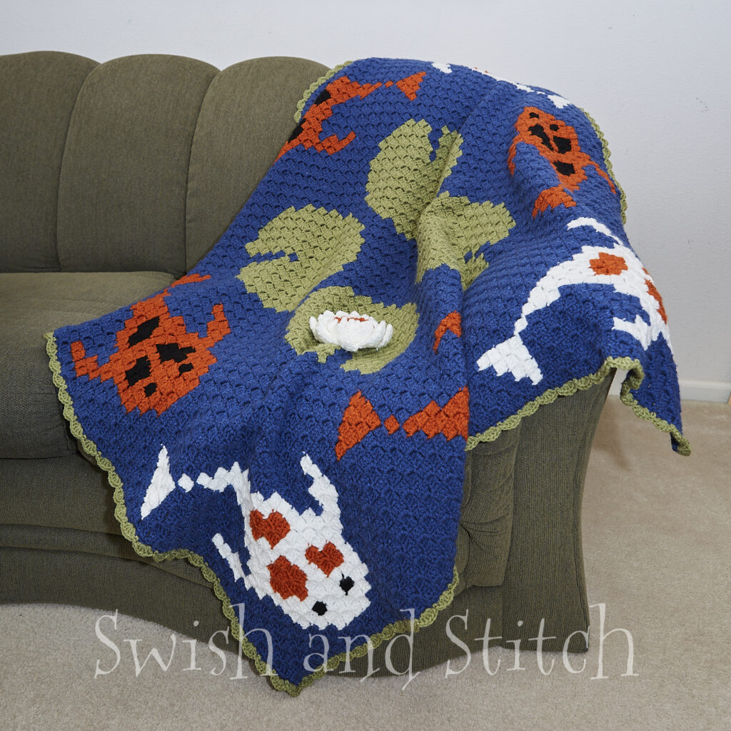 Tranquil Koi Pond C2C Croceht Throw Afghan draped on couch