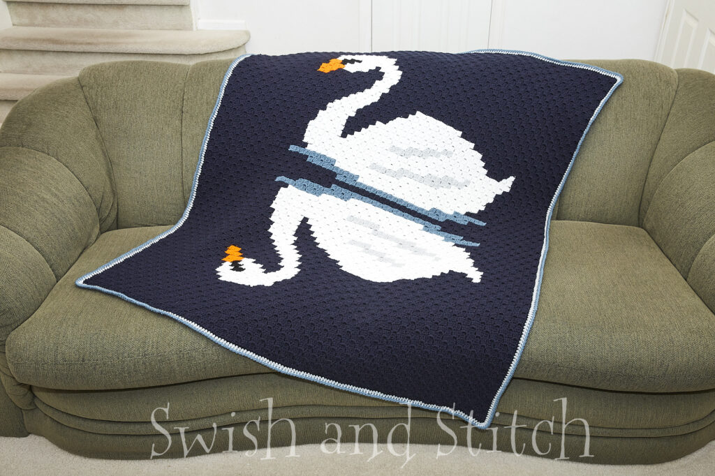 Reflection swans C2C crochet afghan on couch