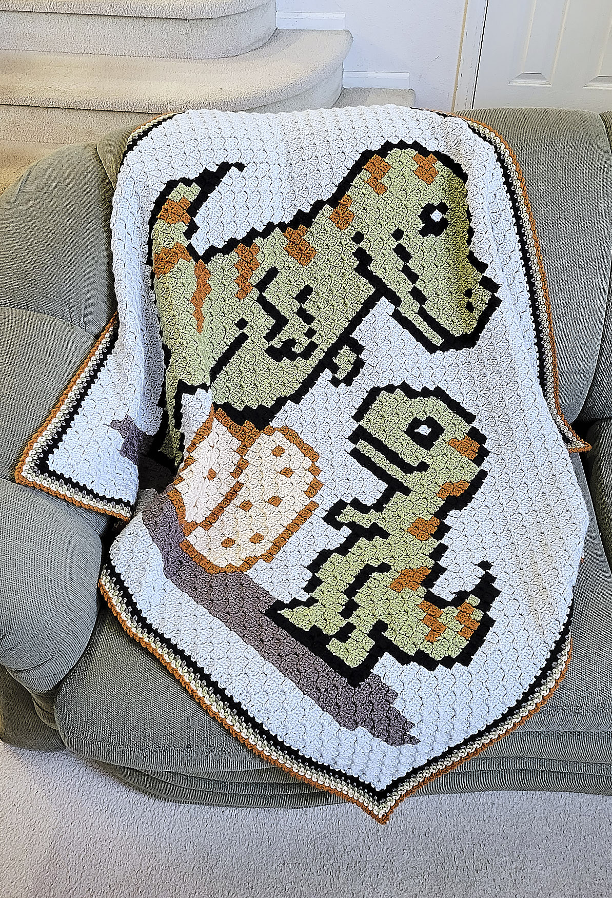 Dino mother and baby afghan on couch